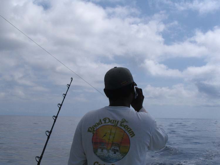 quepos-27-on-cell-phone